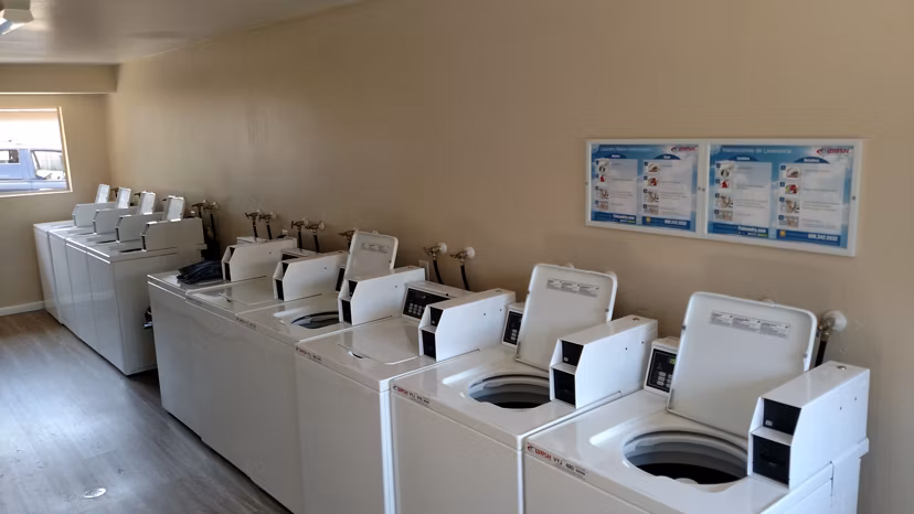 Laundry facility with top-loading machines at Amara Apartments, a Greystar luxury property, offering convenience and comfort for residents