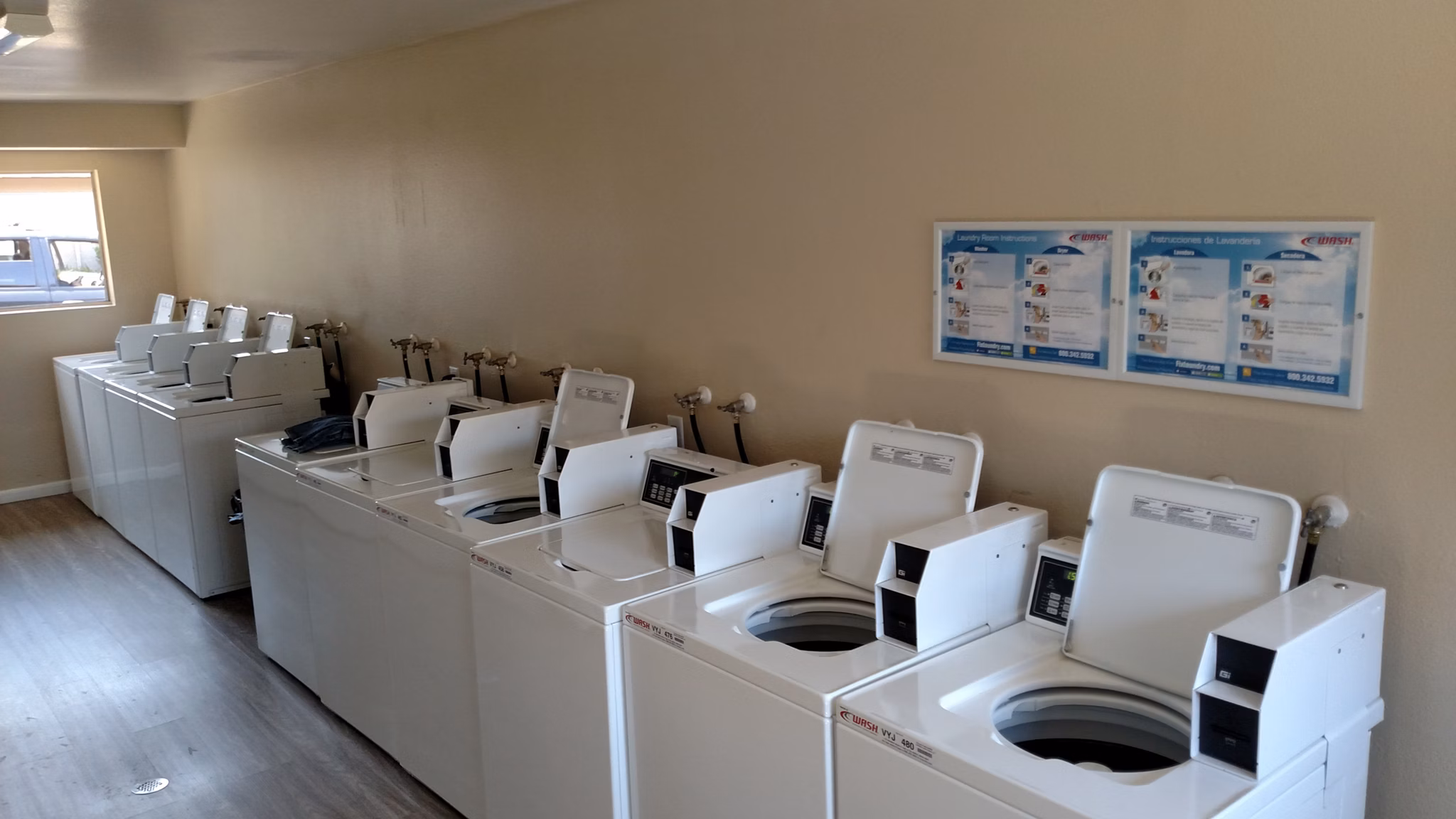 Laundry facility with top-loading machines at Amara Apartments, a Greystar luxury property, offering convenience and comfort for residents