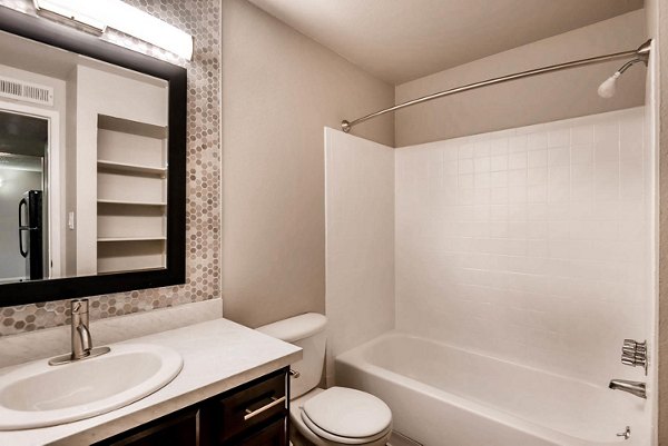 Bathroom with modern fixtures and granite countertops at Copperwood Apartments, luxury residences by Greystar