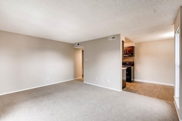 Spacious living room with modern decor and large windows at Copperwood Apartments