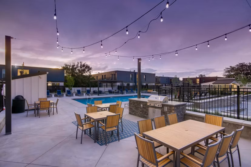 Sunlit outdoor pool with modern loungers at Copperwood Apartments, ideal for relaxation and leisure activities