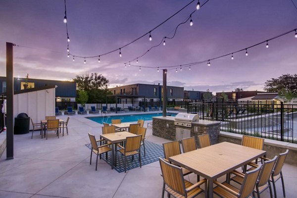 Sunlit outdoor pool with modern loungers at Copperwood Apartments, ideal for relaxation and leisure activities