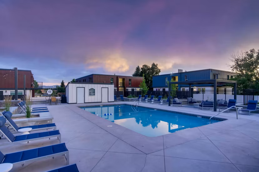 Luxurious outdoor pool surrounded by lush landscaping at Copperwood Apartments