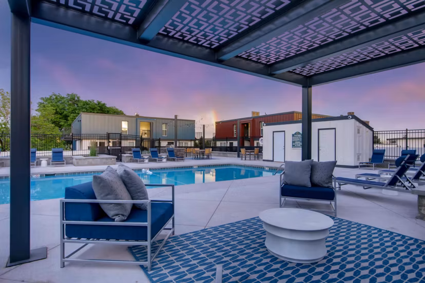 Relaxing outdoor pool with lounge chairs and lush landscaping at Copperwood Apartments, a luxury residence by Greystar