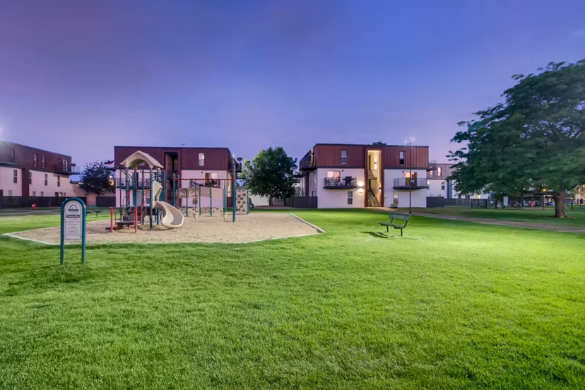 Children's playground with slides and swings at Copperwood Apartments, offering family-friendly amenities in a welcoming community