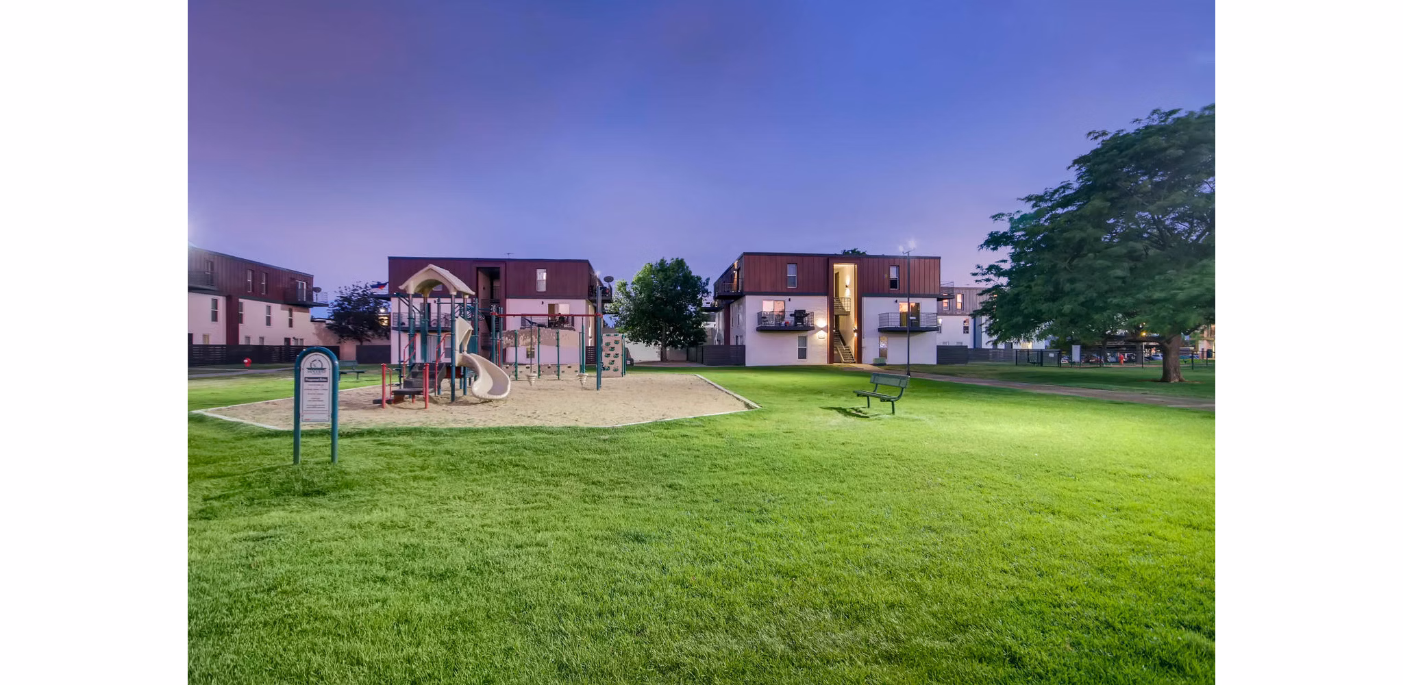 Children's playground with slides and swings at Copperwood Apartments, offering family-friendly amenities in a welcoming community