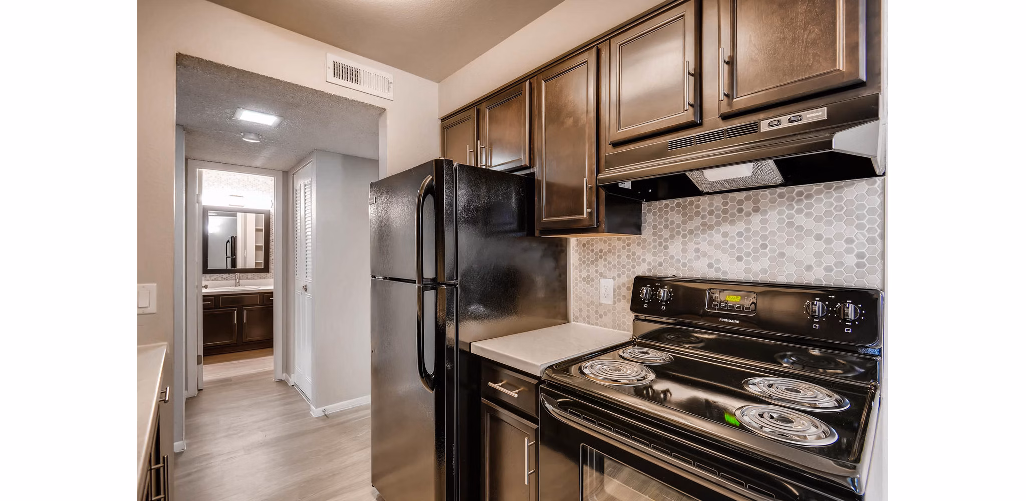 Modern kitchen with stainless steel appliances at Copperwood Apartments