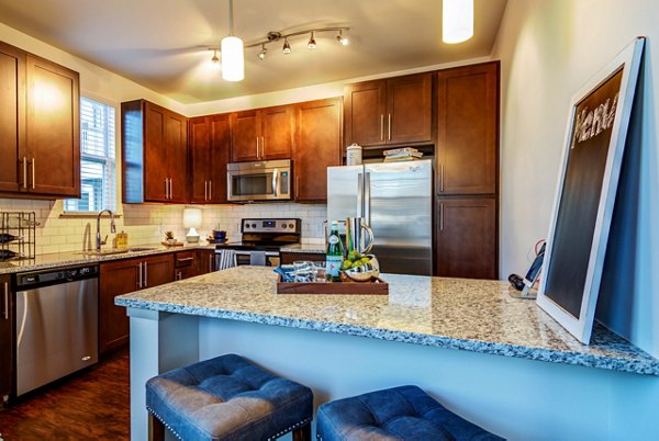 Modern kitchen with stainless steel appliances in Element Ballantyne Apartments