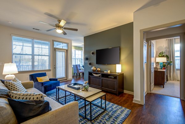 Spacious living room with modern decor and natural light at Element Ballantyne Apartments