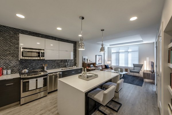 Pike and Rose Pallas: Contemporary kitchen design with stainless steel appliances and modern finishes in North Bethesda apartments