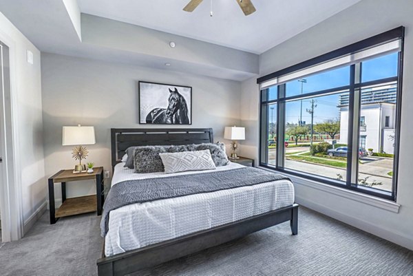 Modern bedroom with stylish decor at Novel River Oaks Apartments, offering a luxurious living experience in a prime location