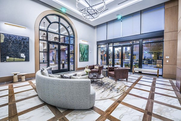 Modern clubhouse lobby featuring elegant seating and art displays at Novel River Oaks Apartments