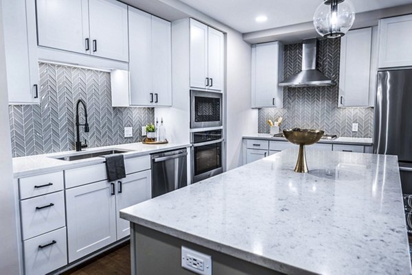 Contemporary kitchen with sleek cabinetry and modern appliances at Novel River Oaks Apartments