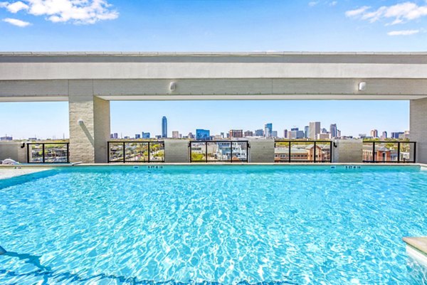 Resort-style pool with shaded loungers at Novel River Oaks Apartments offering luxury living in the heart of Houston