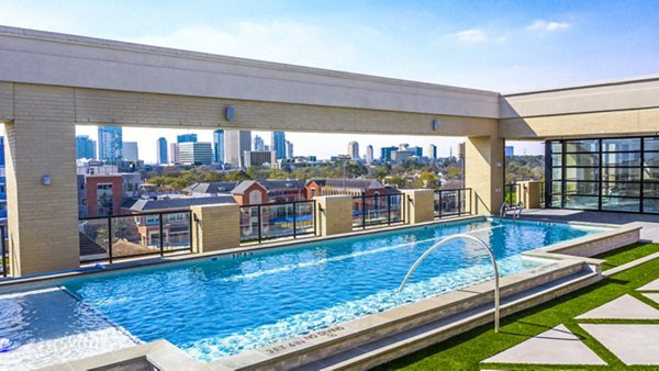 Luxury apartment pool at Novel River Oaks with modern lounge areas and city views