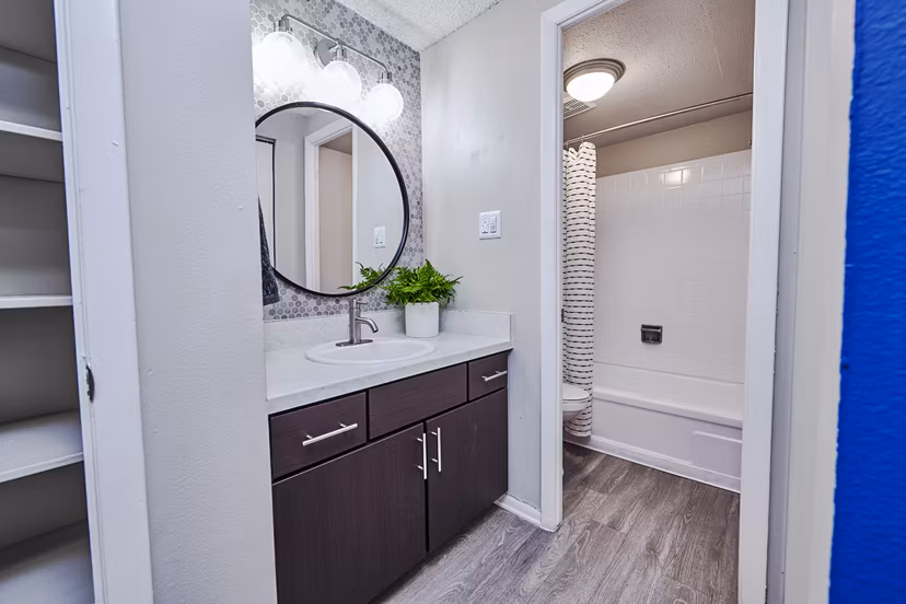 Modern bathroom with sleek fixtures and granite countertops in The Lodge Apartment Homes