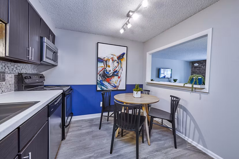 Modern dining room with elegant lighting at The Lodge Apartment Homes in Denver, CO.