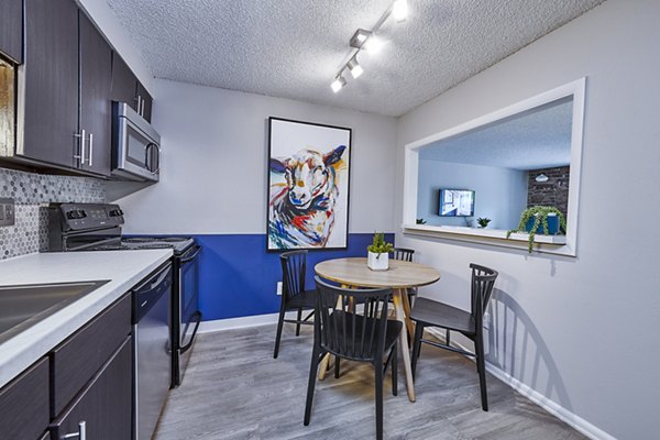 Modern dining room with elegant lighting at The Lodge Apartment Homes in Denver, CO.