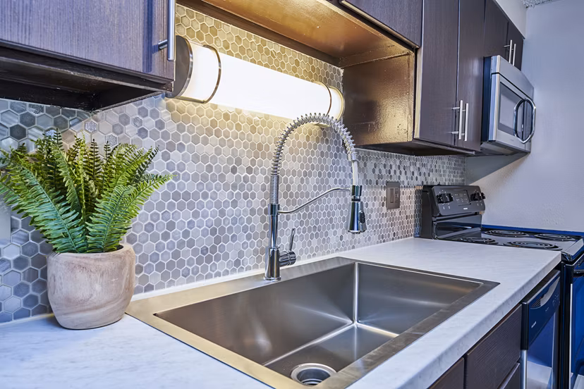 Modern kitchen with sleek countertops and stainless steel appliances at The Lodge Apartment Homes