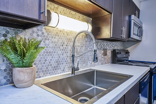 Modern kitchen with sleek countertops and stainless steel appliances at The Lodge Apartment Homes