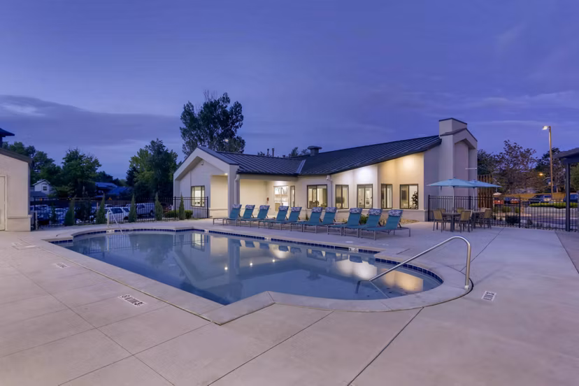 Modern outdoor pool area with lounge seating at The Lodge Apartment Homes