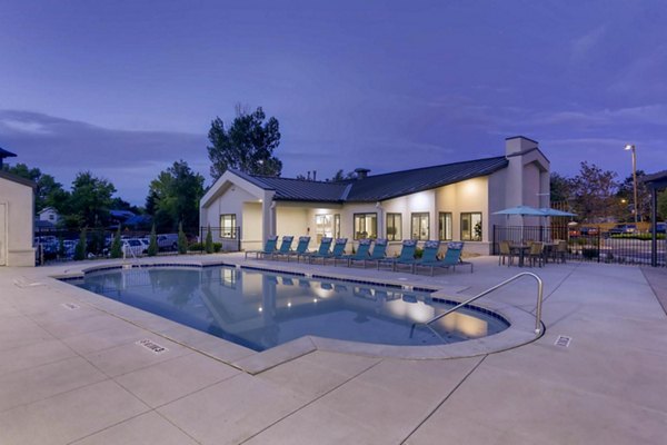 Modern outdoor pool area with lounge seating at The Lodge Apartment Homes