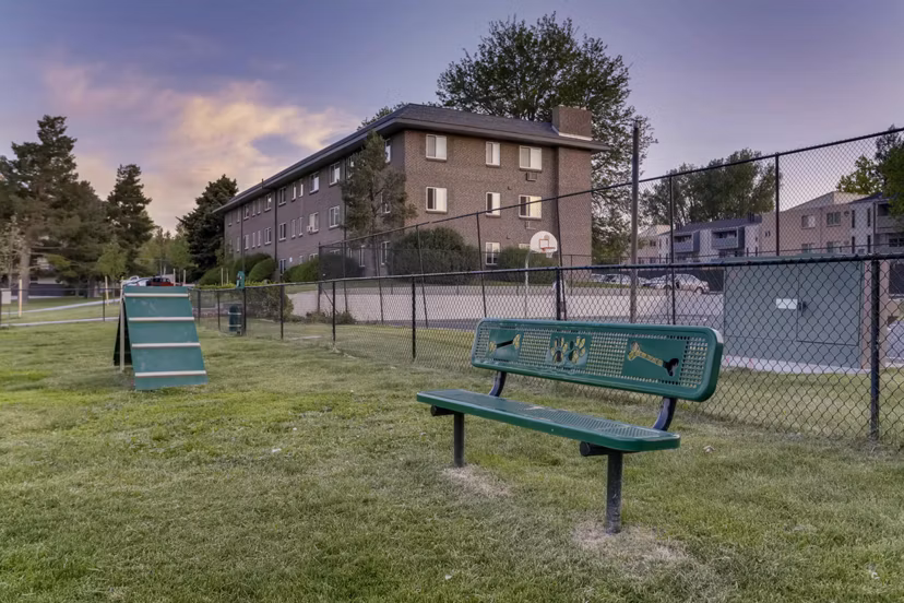 The Lodge Apartment Homes: Off-leash dog park with agility equipment in a serene wooded setting