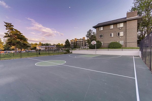 Spacious indoor basketball court at The Lodge Apartment Homes, featuring premium flooring and ample lighting for residents to enjoy