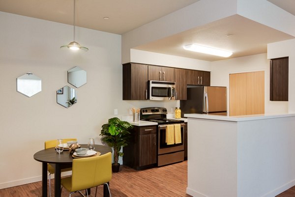 Dining room featuring elegant wooden furniture at The Bailey at Amazon Creek Apartments Luxurious space ideal for gatherings and comfort