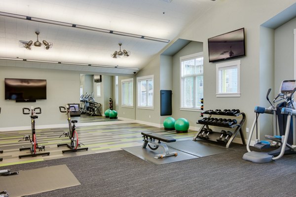 Fully equipped fitness room with modern machines at The Bailey at Amazon Creek Apartments