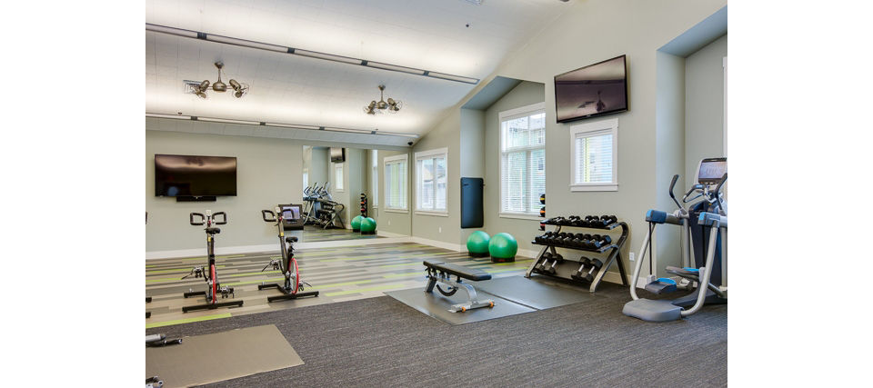 Fully equipped fitness room with modern machines at The Bailey at Amazon Creek Apartments