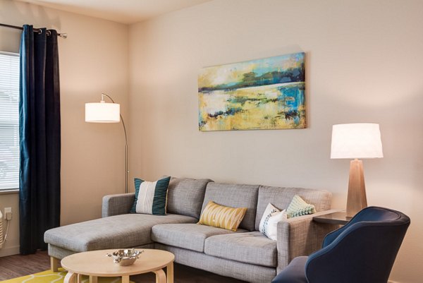 Spacious living room with modern furnishings in The Bailey at Amazon Creek Apartments