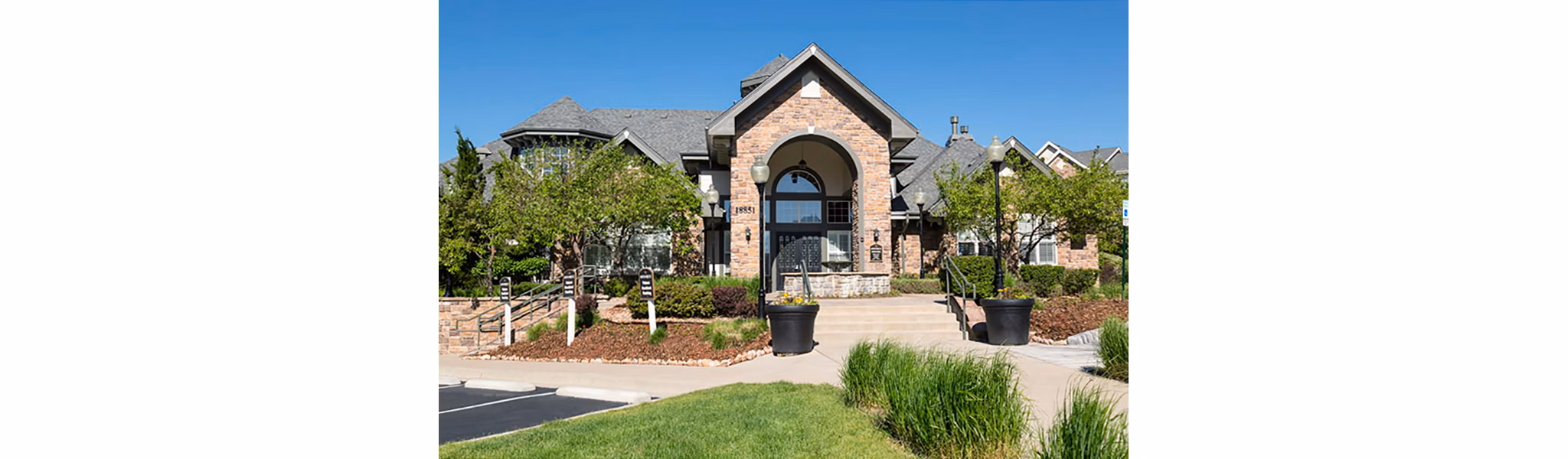 Aspen Ridge Apartments: Scenic view of luxury apartments in suburban setting