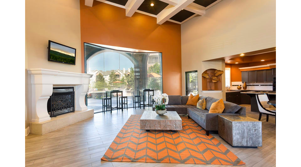 Clubhouse with modern furnishings at Aspen Ridge Apartments, offering a luxurious space for residents to relax and socialize