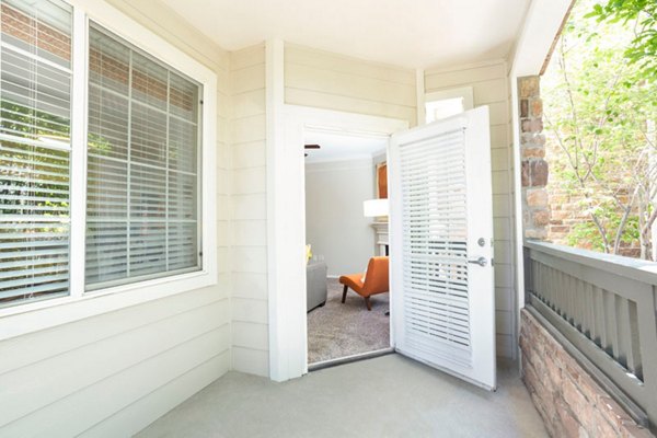Aspen Ridge Apartments: Cozy patio balcony with seating overlooking scenic views