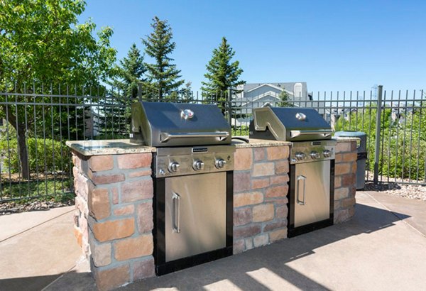 Outdoor grill area with modern seating at Aspen Ridge Apartments, offering a perfect gathering space for residents and guests