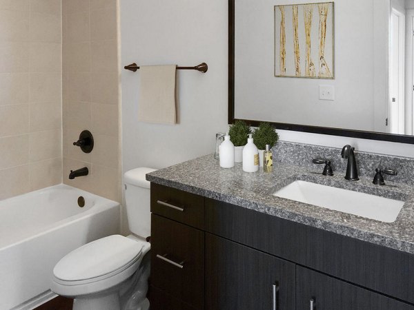 Large bathroom with modern fixtures at M Station Apartments
