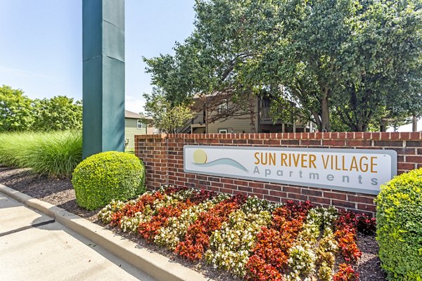 Signage at Sun River Village Apartments featuring luxury living in a vibrant community