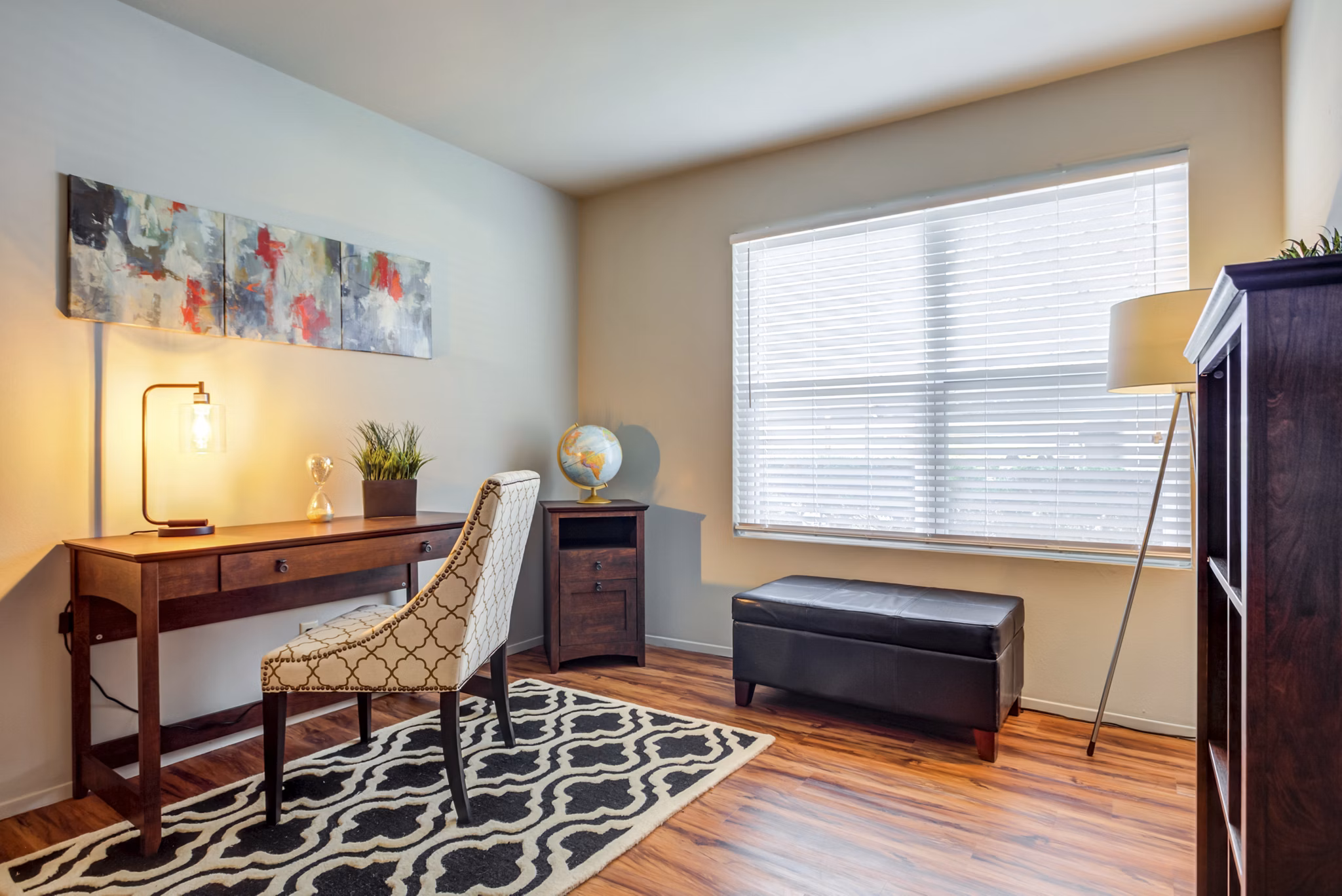 Cozy bedroom and home office combo at Sun River Village Apartments, ideal for luxury apartment living