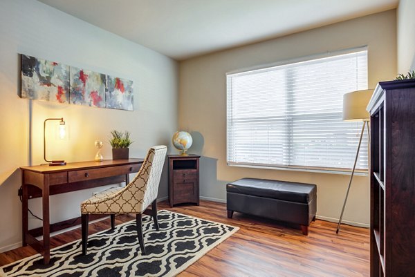 Cozy bedroom and home office combo at Sun River Village Apartments, ideal for luxury apartment living