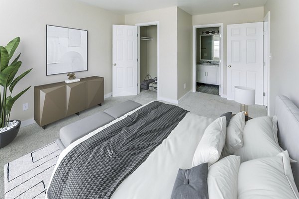 Cozy bedroom with modern decor in Sun River Village Apartments, offering luxury living and premium amenities