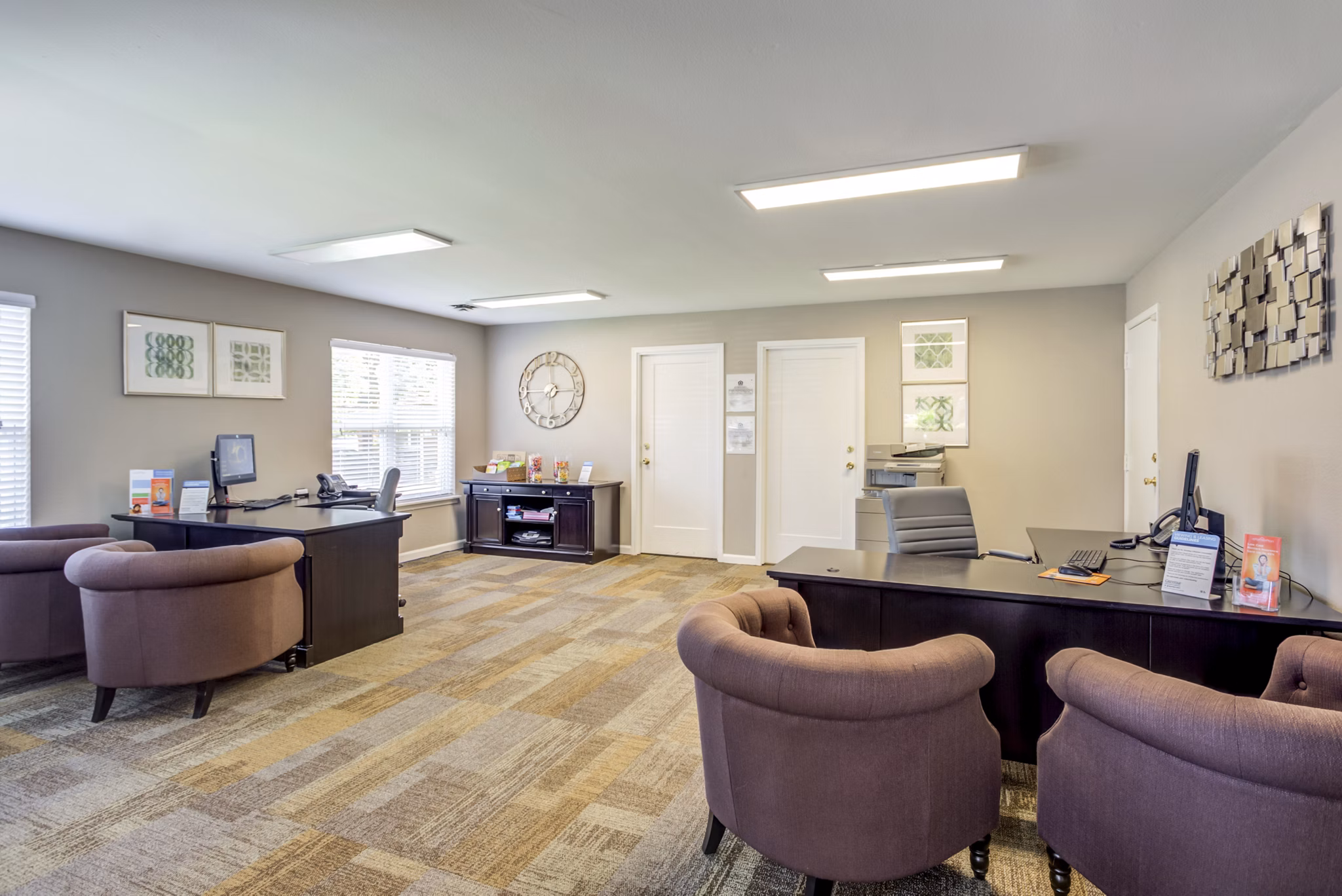 Modern clubhouse with stylish seating and fireplace at Sun River Village Apartments