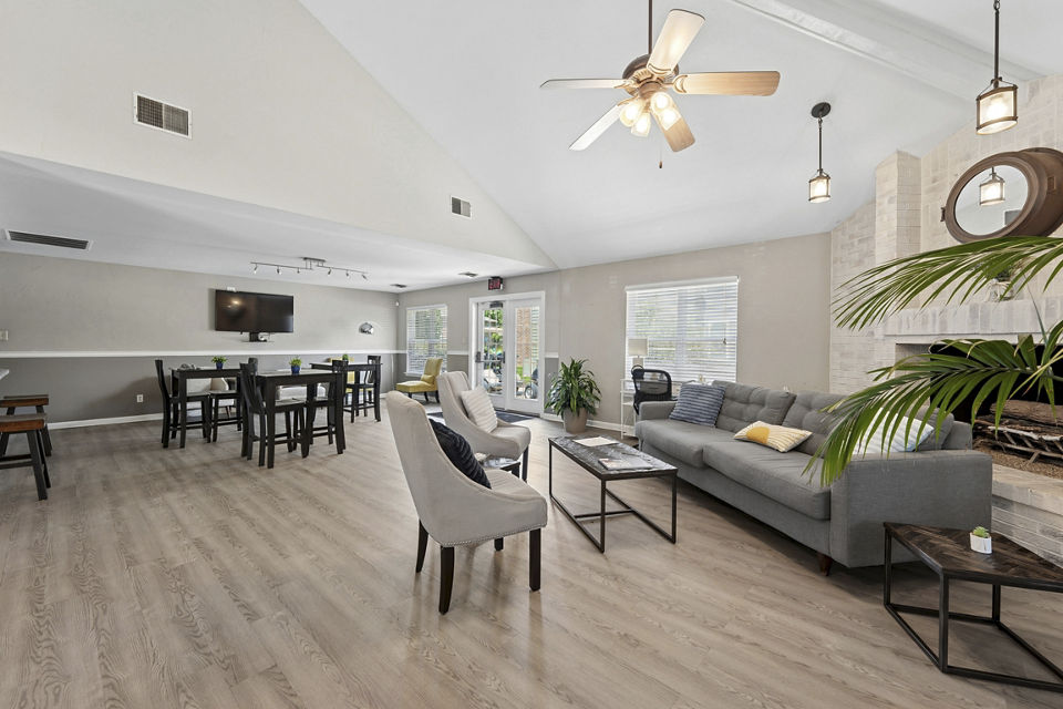 Modern clubhouse with stylish seating and fireplace at Sun River Village Apartments