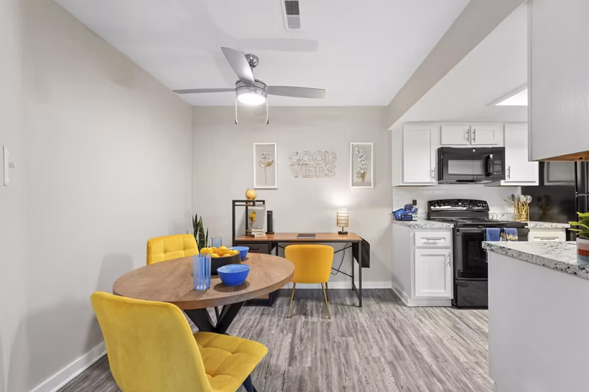 Dining room featuring modern dÃ©cor and elegant lighting at Sun River Village Apartments in a luxury community setting