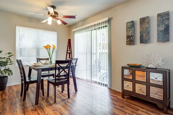 Dining room featuring modern dÃ©cor and elegant lighting at Sun River Village Apartments in a luxury community setting