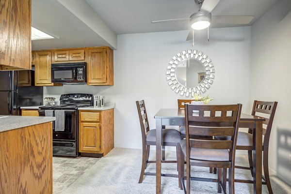 Dining area with modern decor and hardwood flooring at Sun River Village Apartments, ideal for luxury living near local conveniences