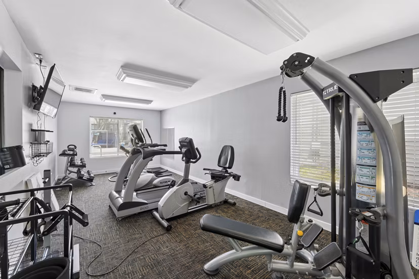 Modern fitness center with state-of-the-art equipment at Sun River Village Apartments