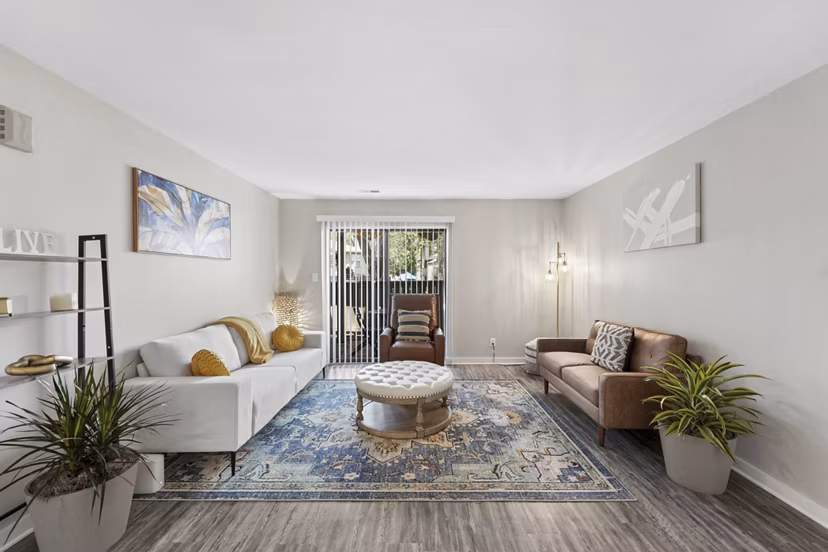 Cozy living room with modern decor and natural light at Sun River Village Apartments
