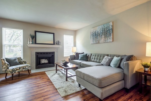 Cozy living room with modern decor and natural light at Sun River Village Apartments