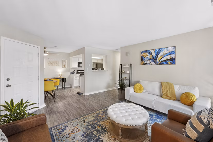 Living room with contemporary design and ample natural light at Sun River Village Apartments